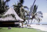 French Polynesia, tourists outside cabin at Bali Hai Resort on Moorea Island