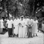 Newly-weds and family with well-wishers pose for photo