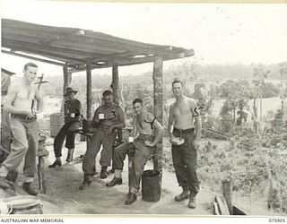 HANSA BAY AREA, NEW GUINEA. 1944-09-05. COOKS OF THE NO. 8 PLATOON, A COMPANY, 25TH INFANTRY BATTALION, ENJOY A CUP OF TEA DURING A BREAK IN THEIR MORNING CHORES. IDENTIFIED PERSONNEL ARE: N266598 ..