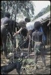 Food preparation: men and Ann Rappaport build above-ground oven