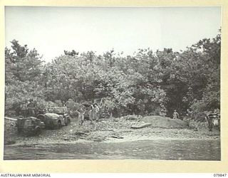 WAITAVALO PLANTATION, NEW BRITAIN. 1945-03-15. THE BEACHHEAD NEAR THE PLANTATION WHERE THE 6TH FIELD AMBULANCE, ARMY MEDICAL CORPS IS ESTABLISHED. WOUNDED RECEIVE TREATMENT AT THIS POINT BEFORE ..