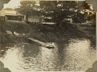 Woman doing laundry on a riverside jetty in Fiji, 1928