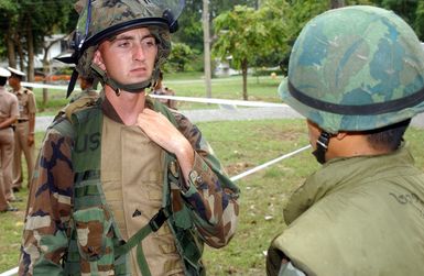 US Marine Corps (USMC) Corporal (CPL) Mathew Solmmes, left and Royal Thai Marine (CHIEF PETTY Officer First Class) PO1 Wattanapan Chantarasaen, consult on tactics in order to protect Evacuees during a Non-Combatant Evacuation Operation (NEO), part of Exercise COBRA GOLD 2003. Corporal (CPL) Mathew Solmmes, is attached to the 1ST Battalion, 3rd Marines, from Kaneohe Bay, Hawaii