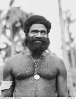 LUNGGA, GUADALCANAL, SOLOMON ISLANDS, 1943-10. SERGEANT (SGT) YAUWIKA, A MEMBER OF THE NATIVE CONSTABULARY, WEARING THE LOYAL SERVICES MEDAL THAT THE DEPUTY SUPERVISING INTELLIGENCE OFFICER (DSIO), ..