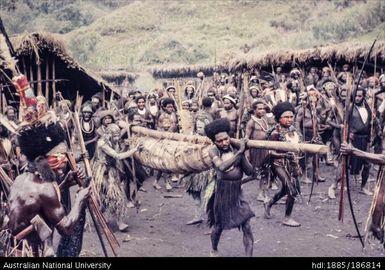 Hunters carrying bundle back to village