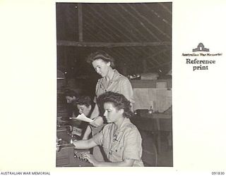 LAE, NEW GUINEA, 1945-05-15. CRAFTSWOMAN L. BATTY (1), AND CRAFTSWOMAN L.E. CRAIG (2), WORKING WITH CORPS OF AUSTRALIAN ELECTRICAL AND MECHANICAL ENGINEERS, HQ LAE BASE SUB AREA. A FEW DAYS AFTER ..