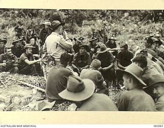 BABIANG, NEW GUINEA. 1944-11-06. CAPTAIN J. ROBINSON OF ATIS, (ALLIED TRANSLATOR INTERPRETATION SECTION) (1), GIVES A TALK TO MEMBERS OF C TROOP, 2/10 COMMANDO SQUADRON ON METHODS OF HANDLING ..