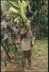 Maenaa'adi with plants for ritual. His older brother Dangeabe'u is behind him