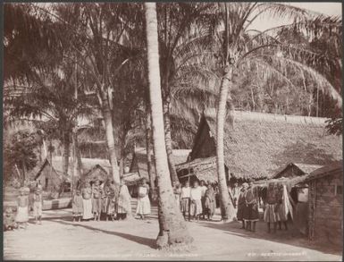Local people standing outside houses in the village of Mindoru, Ysabel, Solomon Islands, 1906 / J.W. Beattie
