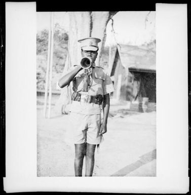 Uniformed man playing a bugle, Rabaul, New Guinea, ca. 1936 / Sarah Chinnery