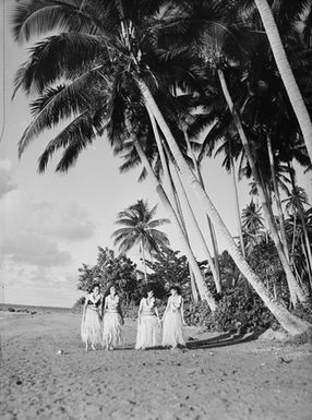 [View of four Pacific island women on shoreline]