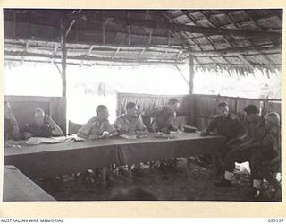 CAPE WOM, NEW GUINEA, 1945-12-01. VIEW OF THE COURT SHOWING PERSONNEL OF THE BENCH AT THE TRIAL OF JAPANESE LIEUTENANT TAZAKI, WHO WAS CHARGED WITH AND LATER SENTENCED TO DEATH FOR CANNIBALISM, ..