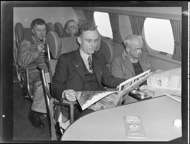 Interior view of aircraft, includes unidentified man on Tasman Empire Airways air boat RMA New Zealand ZK-AME flight to Fiji