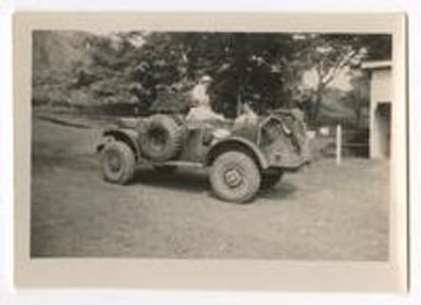 Army Nurse and two male service members in army vehicle, Fiji