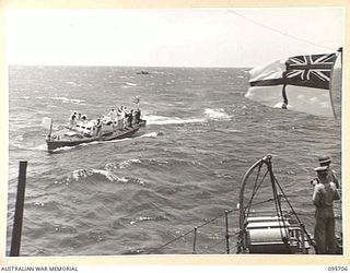 AT SEA OFF RABAUL, NEW BRITAIN. 1945-09-04. SUB-LIEUTENANT L.G. DINNING, OFFICER OF THE WATCH, ABOARD HMAS VENDETTA ON THE LOOKOUT FOR JAPANESE ENVOYS FROM RABAUL, AS THE SHIP PROCEEDS TO A SEA ..