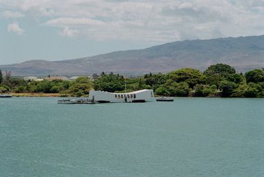 A view of the USS ARIZONA Memorial, it spans the wreck of the Battleship USS ARIZONA (BB 39). The vessel was destroyed in the opening moments of the Japanese attack on Pearl Harbor on December 7th, 1941. The ship is the final resting place for over 1,100 crewmen