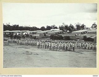 ENOGGERA, QUEENSLAND. 1945-04-26. A GENERAL VIEW SHOWING THE CONTROLLER OF AUSTRALIAN WOMEN'S ARMY SERVICE COLONEL S.H. IRVING INSPECTING NO. 10 PLATOON OF AUSTRALIAN WOMEN'S ARMY SERVICE BARRACK ..