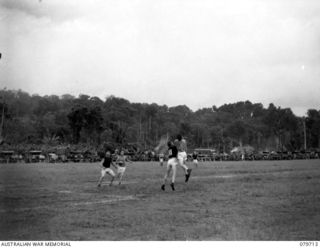 TOROKINA, BOUGAINVILLE, SOLOMAN ISLAND. 1945-03-11. THE AUSTRALIAN RULES FOOTBALL MATCH BETWEEN THE 24TH AND THE 58/59TH INFANTRY BATTALION DURING THE SPORTS CARNIVAL CONDUCTED BY HQ 15TH INFANTRY ..