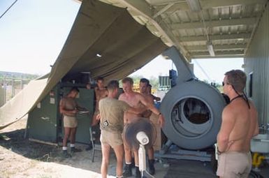 Construction Electrician Second Class (CE2) (DV) Joseph L. Wallis of Underwater Construction Team Two (UCT-2) performs a simulated neurological examination for possible decompression sickness on Steelworker Second Class (SW2) (DV) Michael Grier during recompression chamber training at the Pacific Missile Range Facility at Kauai, Hawaii.(Exact date unknown)