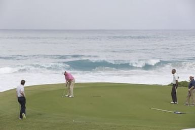Barack Obama plays golf with Prime Minister Najib Razak, Joe Paulsen, and Mike Brush in Kaneohe Bay, Hawaii, December 24, 2014