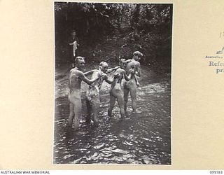 ENGULT RIVER, NEW GUINEA, 1945-08-11. TROOPS OF 2/7 INFANTRY BATTALION BATHING IN THE FAST FLOWING RIVER. IDENTIFIED PERSONNEL ARE:- PRIVATE S.V. SHAW (1); PRIVATE P. MALOY (2); LANCE-CORPORAL A. ..