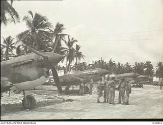 MOMOTE, LOS NEGROS ISLAND, ADMIRALTY ISLANDS. 1944-03-18. RAAF KITTYHAWK AIRCRAFT OF NO. 76 SQUADRON RAAF ON THE CORAL-SURFACED MOMOTE AIRSTRIP, BESIDE THE COCONUT PALM TREES, ONLY SIX DAYS AFTER ..