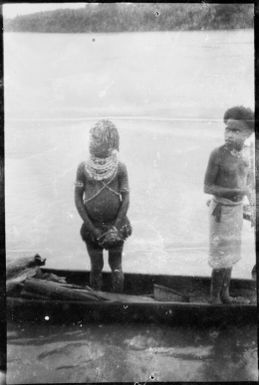 Two people standing in a canoe, Ramu River, New Guinea, 1935, 1 / Sarah Chinnery