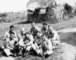 Soldiers on rest and recuperation in front of thatched building, Fiji, 1940s