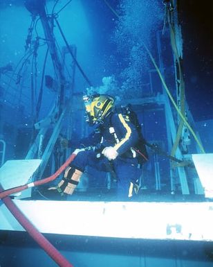A Diver assigned to Mobile Diving and Salvage Unit One (MDSU-1) diver touches down on the deck of Ehime Maru, during recovery operations for the Japanese fishing vessel Ehime Maru off the coast of Hawaii