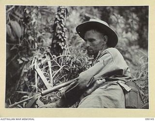 DAGUA, NEW GUINEA. 1945-03-27. GNR D.S. FINLAY, 2/2 FIELD REGIMENT, A FRONT LINE SOLDIER ATTACHED AS AN ARTILLERY SIGNALLER TO THE 2/2 INFANTRY BATTALION, WITH HIS OWEN GUN. BECAUSE OF THE ..