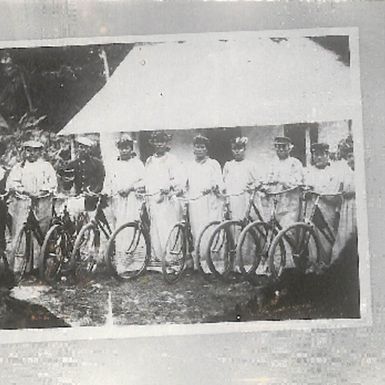 Photo of a group of men with bicycles