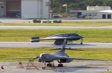 A US Air Force (USAF) B-2 Spirit stealth bomber taxis onto the flightline at Anderson Air Force Base (AFB), Guam (GU), in support of exercise Coronet Bugle 49. The B-2 is deployed to Anderson from Whiteman AFB, Missouri (MO). Close by is a B-1B Lancer bomber aircraft. (SUBSTANDARD)