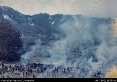 Mendi people creating smoke, mountain scene