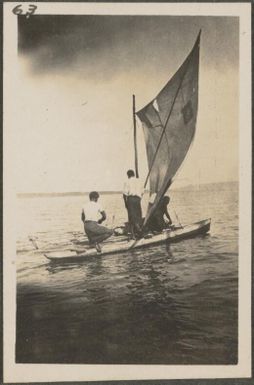 Two Papuan men in a catamaran with a sail, New Britain Island, Papua New Guinea, approximately 1916