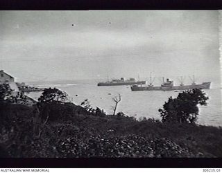 OCEAN ISLAND. C.1940. THE ARMED MERCHANT CRUISER HMAS MANOORA (LEFT) AT HOME BAY WITH THE NORWEGIAN MERCHANT VESSEL VITO LOADING PHOSPHATE. (NAVAL HISTORICAL COLLECTION)