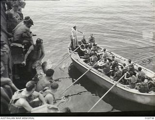 MILNE BAY, PAPUA. C.1944-02. AIRMEN OF NO. 75 SQUADRON RAAF IN THE SHIP'S LIFEBOAT AT BOAT DRILL WHILST AT MILNE BAY EN ROUTE TO LAE