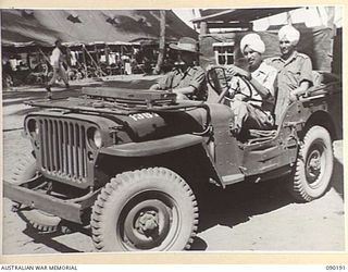 AITAPE, NEW GUINEA. 1945-03-29. THREE INDIAN SOLDIERS ABOUT TO INVESTIGATE THE INTRICACIES OF A JEEP. FORMER PRISONERS OF WAR THEY ARE RECUPERATING AT 104 CASUALTY CLEARING STATION