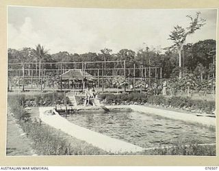 LAE, NEW GUINEA. 1944-10-18. THE SWIMMING POOL AT THE CAMP OF THE DEPUTY ASSISTANT DIRECTOR OF NATIVE LABOUR, LAE BASE SUB AREA, WHICH IS FOR THE USE OF THE MEMBERS OF THE AUSTRALIAN NEW GUINEA ..