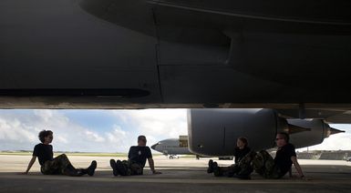 Members of the 116th Air Refueling Squadron, Washington Air National Guard, based at Fairchild Air Force Base, Wash., relax under the shade of a KC-135 Stratotanker aircraft during their deployment at Andersen AFB, Guam, on Nov. 23, 2004. (USAF PHOTO by STAFF SGT. Bennie J. Davis III) (Released)