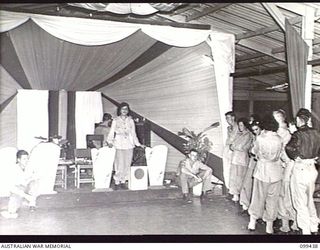 LAE, NEW GUINEA, 1945-12-15. PRIVATE NORMA EADE, AUSTRALIAN WOMEN'S ARMY SERVICE, SINGING DURING THE SHOW STAGED AT THE CHRISTMAS DANCE HELD AT AUSTRALIAN NEW GUINEA ADMINISTRATIVE UNIT ..