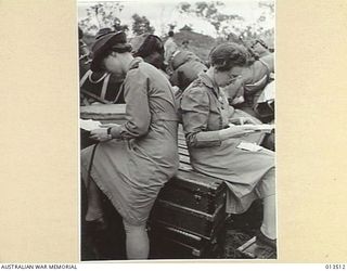 1942-11-11. AUSTRALIAN NURSES RETURN TO NEW GUINEA. TWO NURSES READ LETTERS ON THEIR ARRIVAL AT NEW GUINEA. (NEGATIVE BY G. SILK)