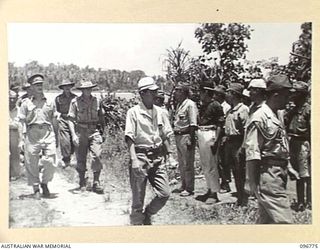 BUKA ISLAND, BOUGAINVILLE AREA, 1945-09-18. JAPANESE TROOPS STANDING TO ATTENTION AS BRIGADIER S.F. LEGGE, OFFICER COMMANDING AUSTRALIAN SURRENDER PARTY FROM HQ 2 CORPS, ARRIVES WITH JAPANESE NAVAL ..