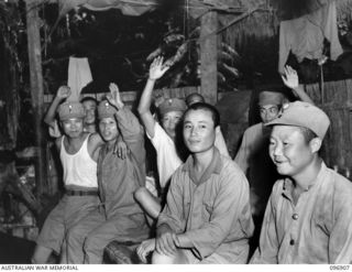 KUMUIA YAMA, RABAUL AREA, NEW BRITAIN. 1945-09-17. LIBERATED CHINESE FROM THE CHINESE INTERNMENT CAMP IN THEIR SLEEPING QUARTERS, SHOW ENTHUSIASM ON THEIR RELEASE. THEY ARE PART OF A COMPLETE UNIT ..