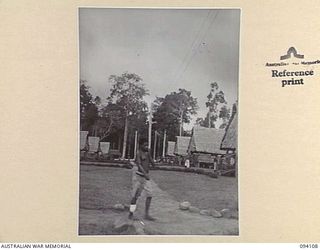 POPONDETTA, NEW GUINEA, 1945-07-02. A VIEW OF THE WARDS AT THE ANGAU NATIVE HOSPITAL. IN THE FOREGROUND IS A NATIVE WHO IS BEING TREATED FOR YAWS