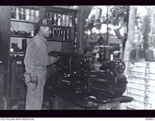 RABAUL, NEW BRITAIN, 1946-03-15. PRECISION WORK BEING CARRIED OUT IN ONE OF THE CAMP WORKSHOPS AT 5 GROUP CAMP. THE CAMP IS ONE OF THIRTEEN GROUP CAMPS ESTABLISHED AROUND RABAUL FOR THE ..