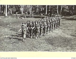 SIAR, NEW GUINEA. 1944-06-21. NO. 8 PLATOON, A COMPANY, 57/60TH INFANTRY BATTALION, MARCHING OFF THE UNIT PARADE GROUND. IDENTIFIED PERSONNEL ARE:- NX137778 LIEUTENANT T.W.R. TEARNE (1); VX142334 ..