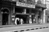 Malaysia, pedestrians walking past stores