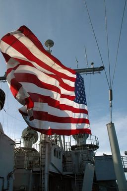 Onboard the US Navy (USN) Ticonderoga Class Guided Missile Cruiser (Aegis) USS COWPENS (CG 63), a giant "battle flag" flies from the yardarm while the ship is underway in the Pacific Ocean, during the opening phases of a joint US-Russian Naval Exercise. A Russian Federation Navy vessel made the first visit to the US Territory of Guam in order to participate in a joint humanitarian assistance and disaster relief exercise