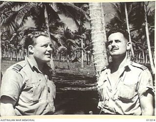 Informal portrait of 400213 Squadron Leader (Sqn Ldr) Keith William (Bluey) Truscott (left) and Adjutant of 76 Squadron 03356 Thomas George Janes, shortly after the unsuccessful Japanese attack on ..