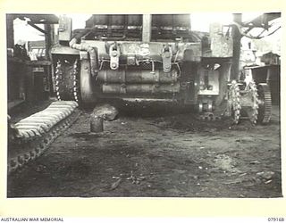 TOROKINA, BOUGAINVILLE ISLAND. 1945-02-21. THE TWO DRIVING SPROCKETS OF A "MATILDA" TANK OF B SQUADRON, 2/4TH ARMOURED REGIMENT EXPOSED TO SHOW THE EFFECTIVENESS OF A SPROCKET SCRAPER DESIGNED BY ..